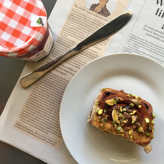 Blackcurrant and pistachio buns with newspaper