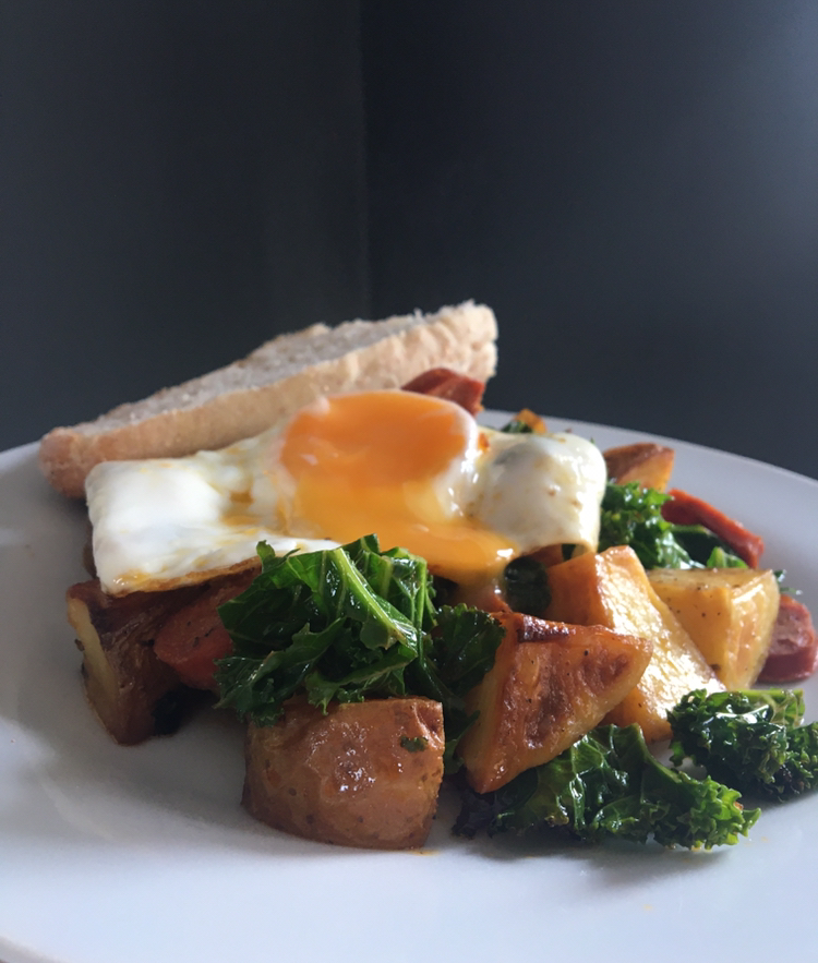 Chorizo, kale & potato hash topped with a fried egg and served with some baguette